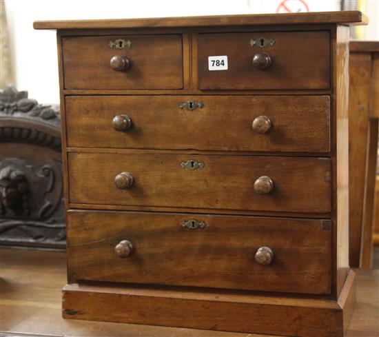 A Victorian miniature chest of two short and three long drawers W.54cm